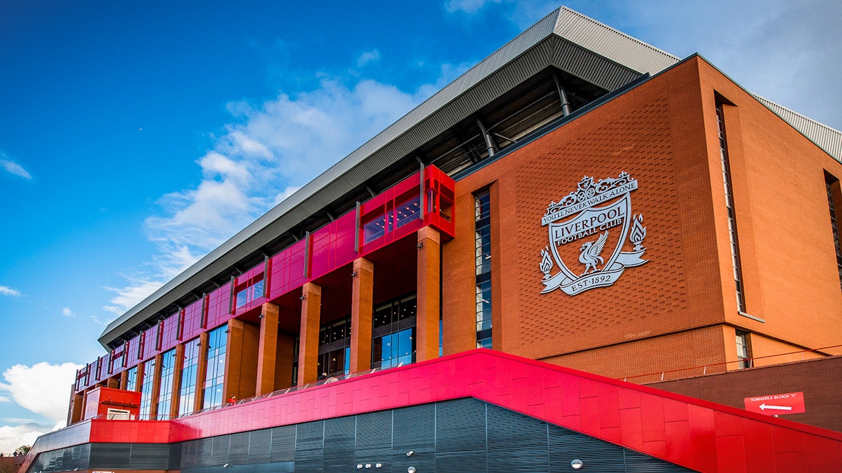 Liverpool FC stadium exterior with club crest, part of Legends Q&A and Stadium Tour.