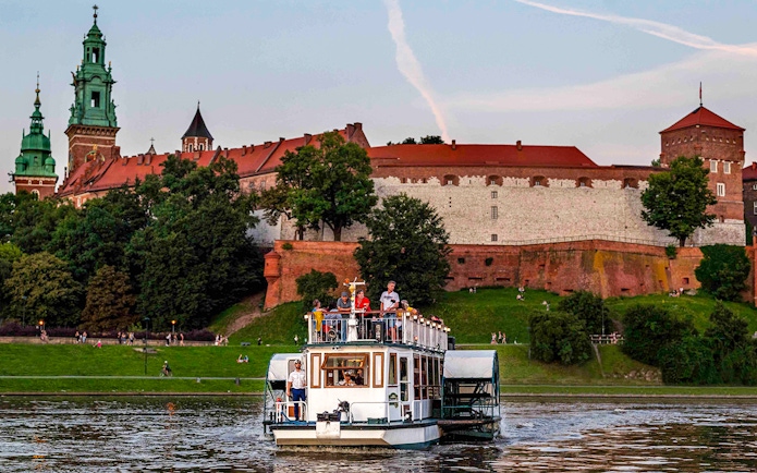 Cruise boat on Vistula River near Wawel Castle, Krakow.