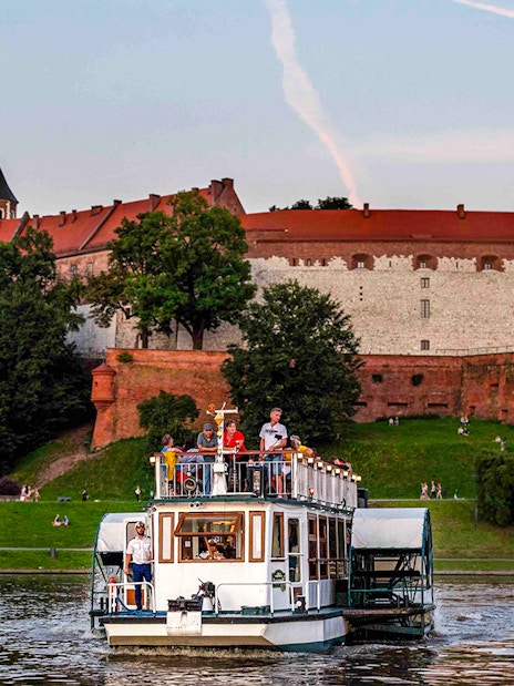 Cruise boat on Vistula River near Wawel Castle, Krakow.