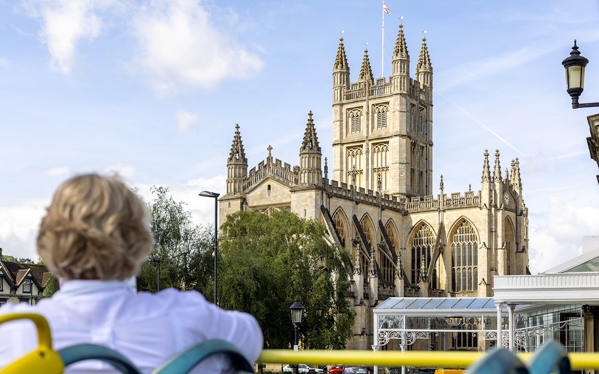 Visitor on Tootbus tour viewing Bath Abbey in Bath, England.
