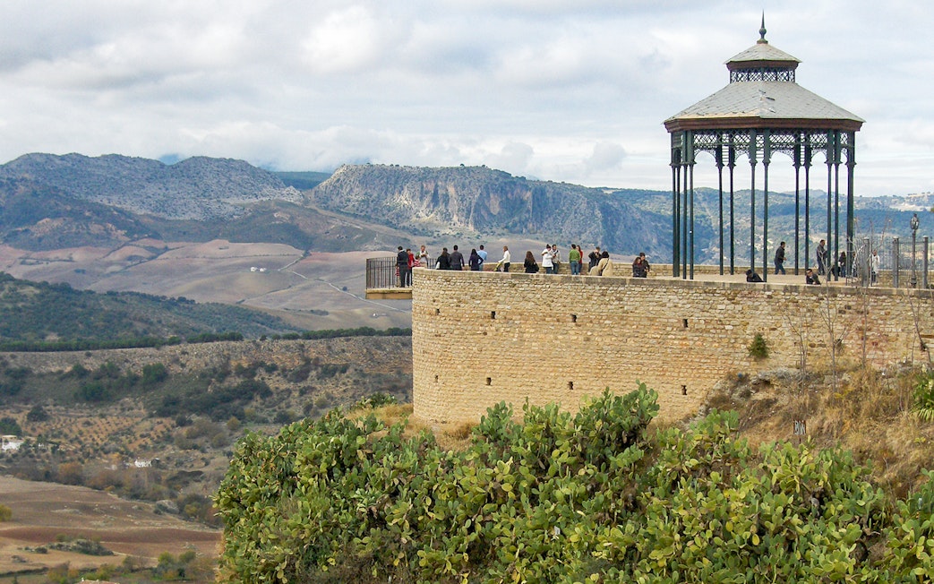 Viewing platform at Ronda with tourists overlooking scenic landscape during guided tour of Setenil de las Bodegas and Ronda.