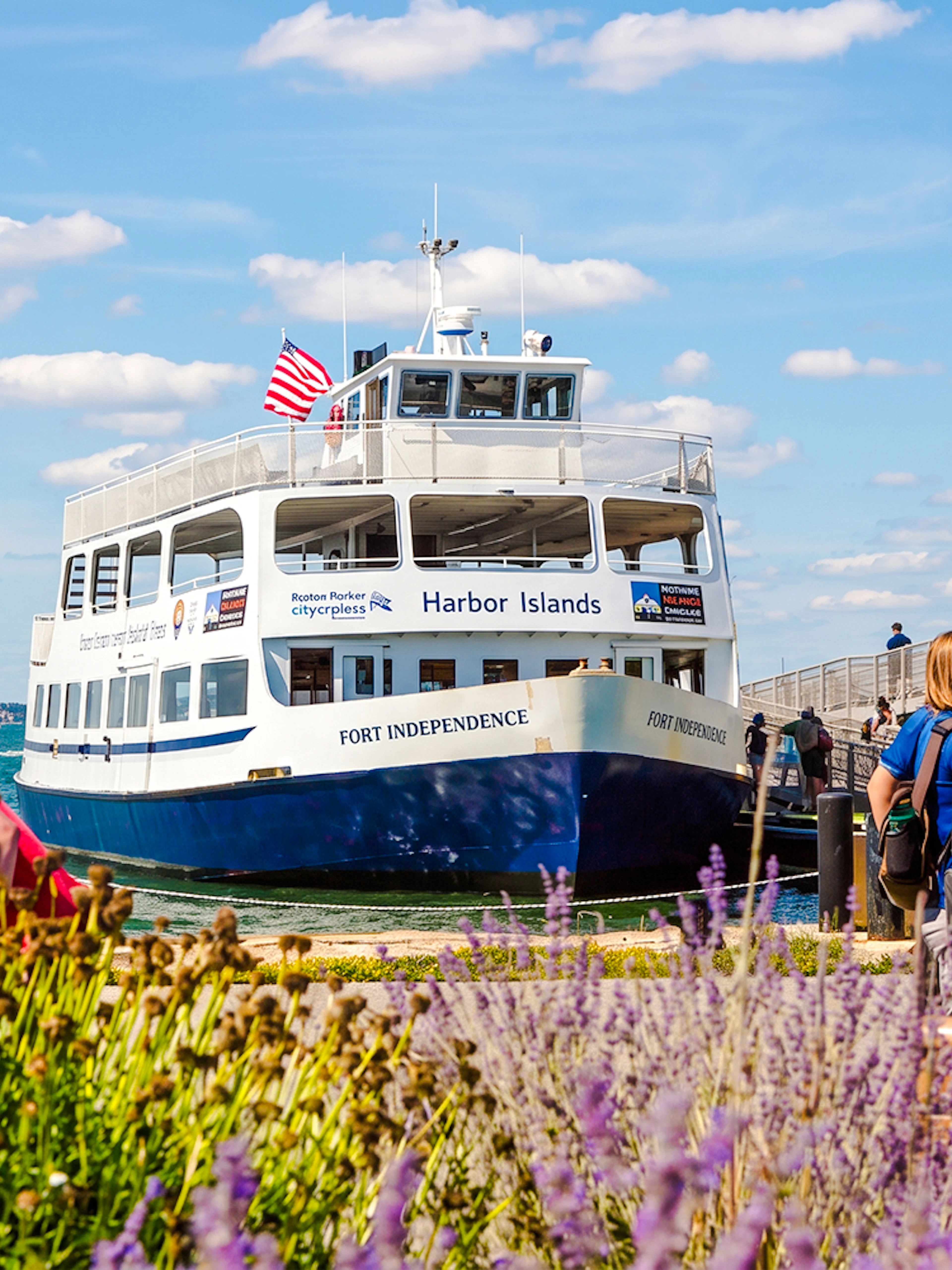 Ferry at dock with passengers boarding for Boston to Spectacle Island trip.