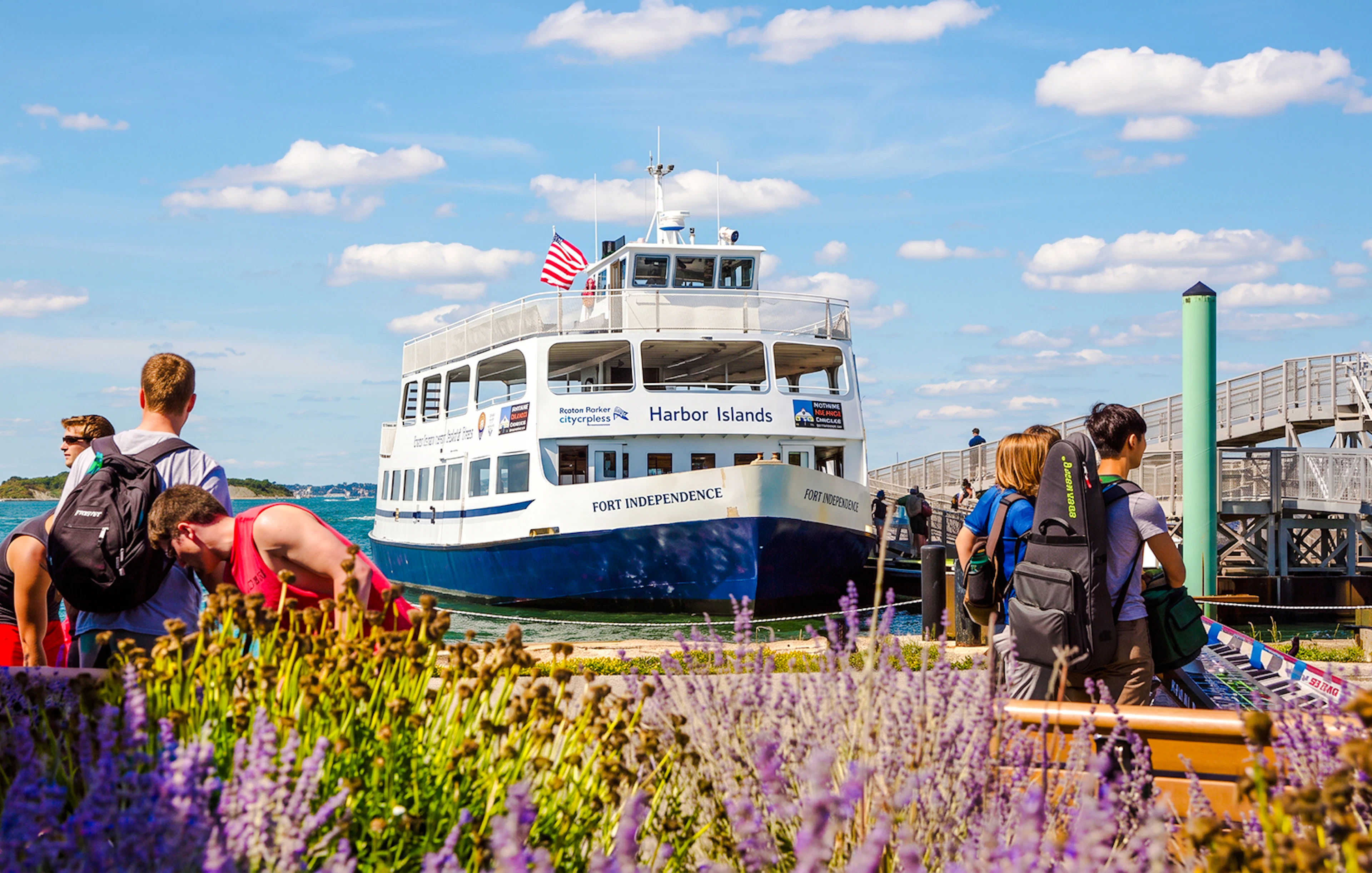 Ferry at dock with passengers boarding for Boston to Spectacle Island trip.