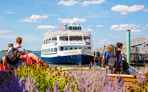 Ferry at dock with passengers boarding for Boston to Spectacle Island trip.