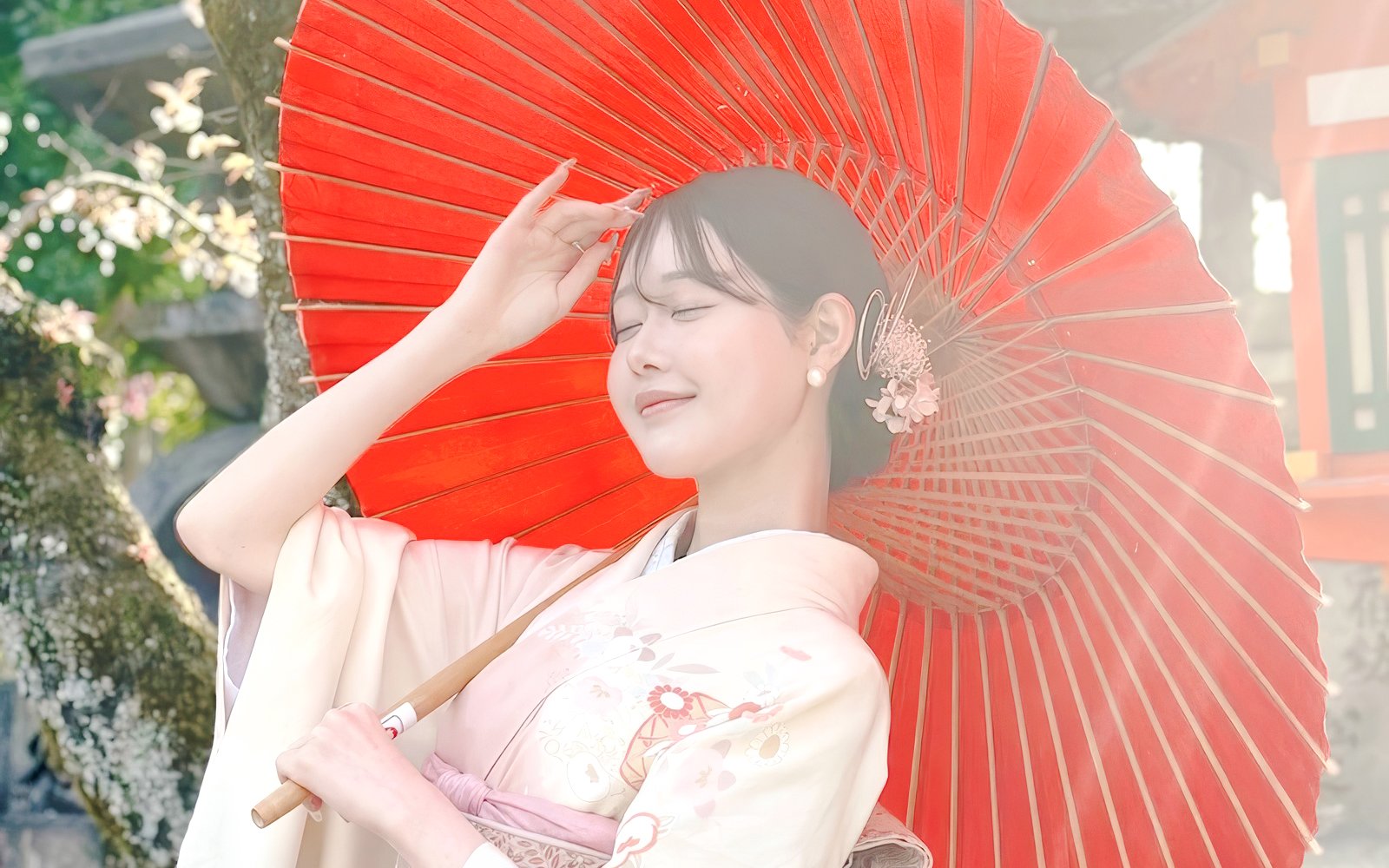 Person in traditional Japanese kimono with red wagasa umbrella.