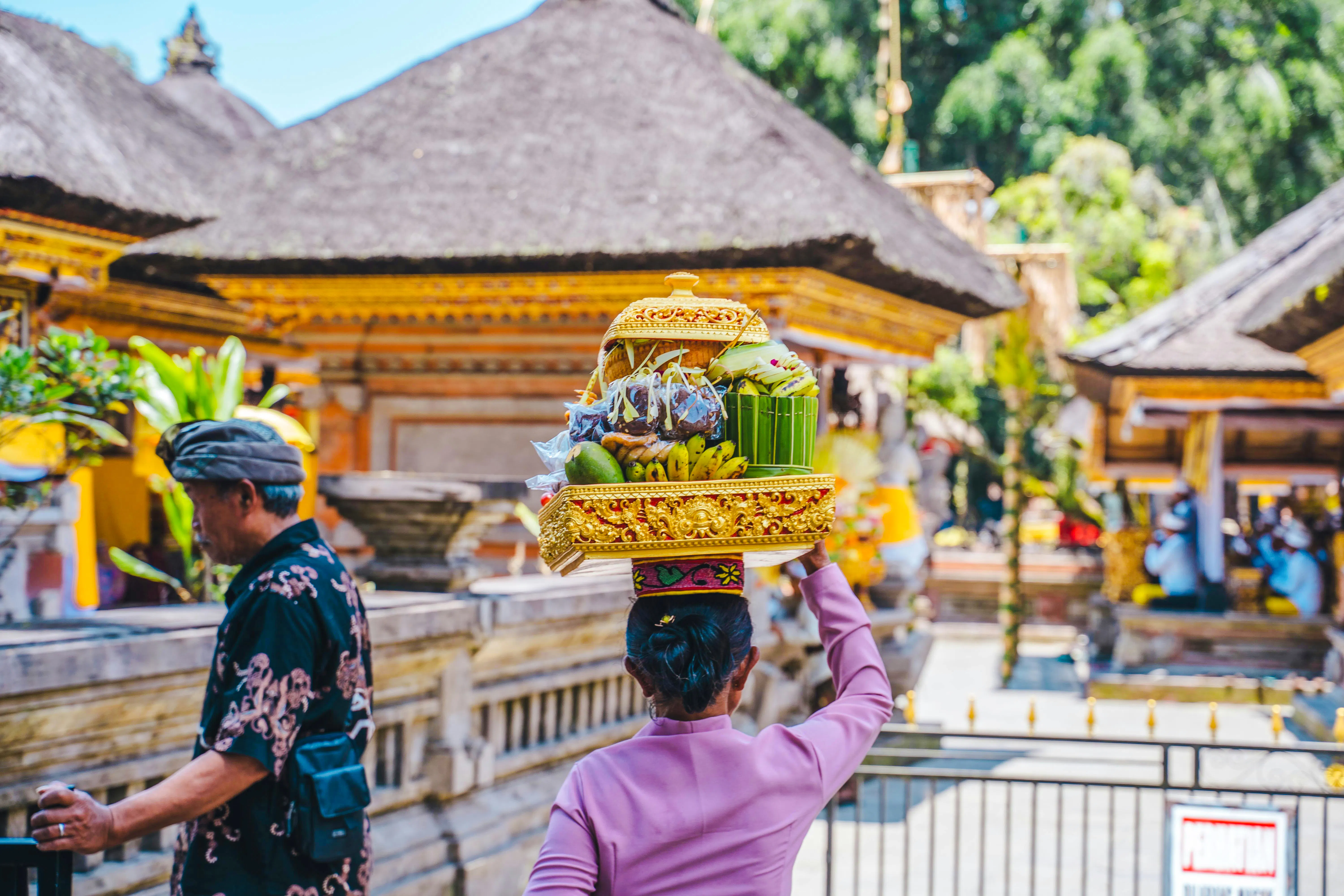 Balinese woman carrying offerings at Tirta Empul Temple, Bali.