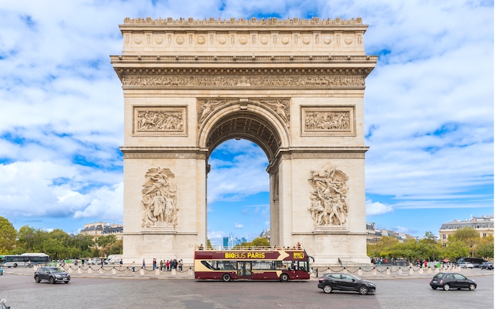 Big Bus tour passing by the Arc de Triomphe in Paris.