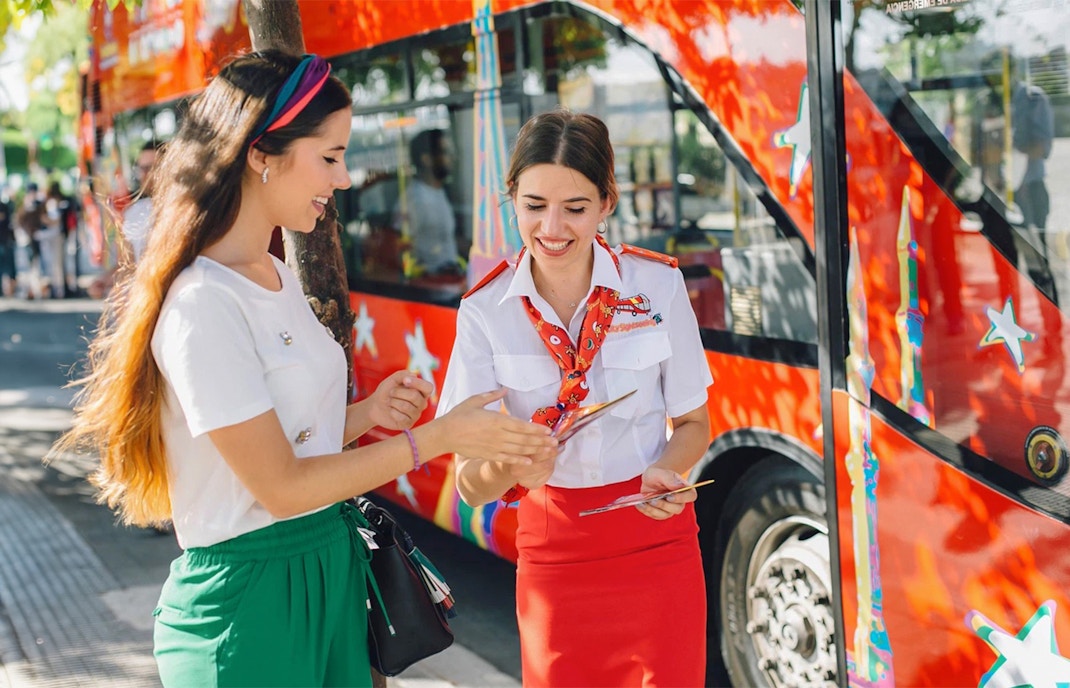 bus crew assisting woman with route map