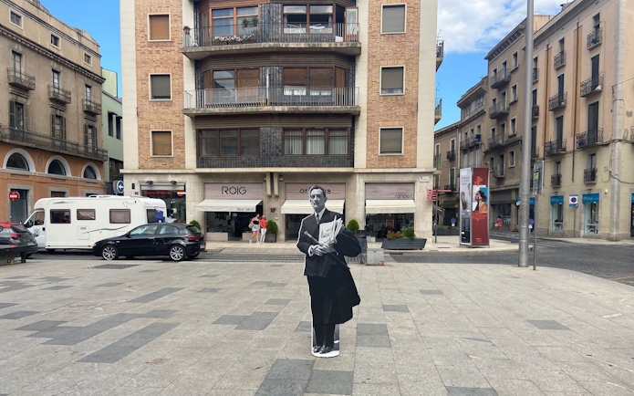 Plaça Major de Figueres with a cutout of a man in front of a building in Catalonia, Spain.