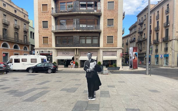 Plaça Major de Figueres with a cutout of a man in front of a building in Catalonia, Spain.