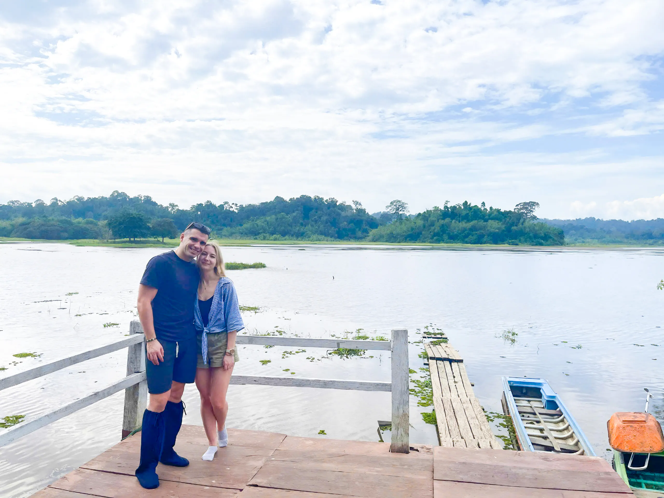Couple standing on a dock by a river in Nam Cat Tien National Park, Vietnam.