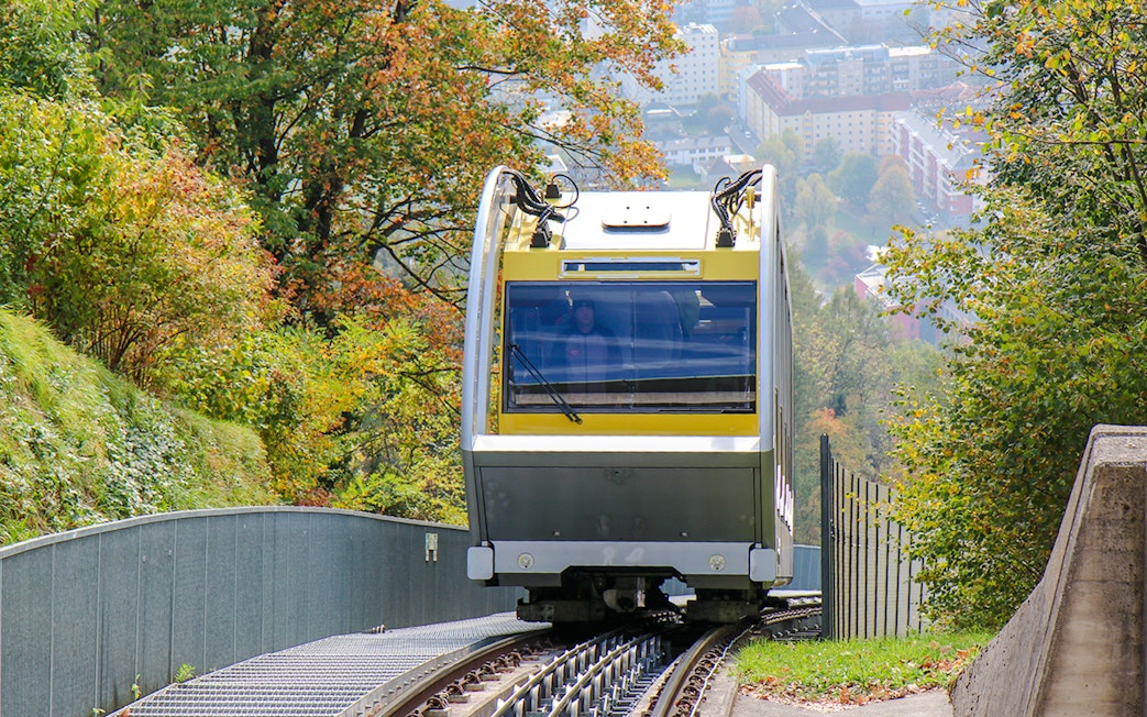 Hungerburg Funicular ascending through lush greenery in Innsbruck, Austria.