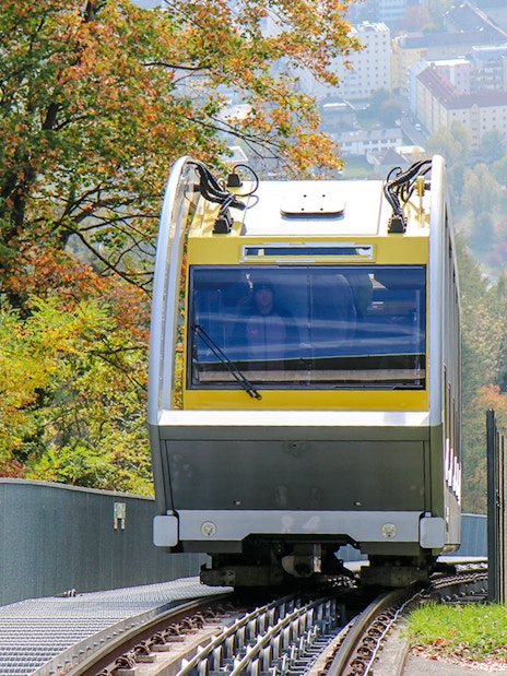 Hungerburg Funicular ascending through lush greenery in Innsbruck, Austria.