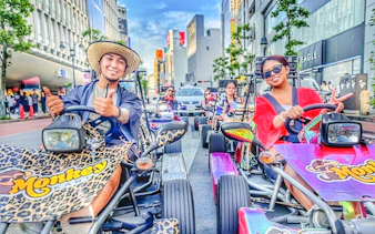 Diverse group enjoying a go-kart tour on vibrant Tokyo streets.