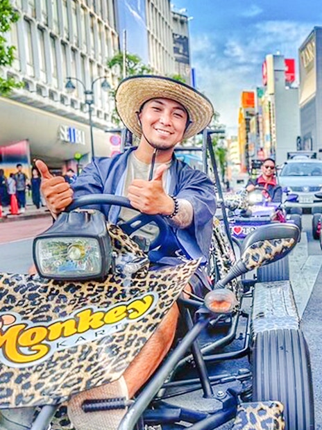 Diverse group enjoying a go-kart tour on vibrant Tokyo streets.