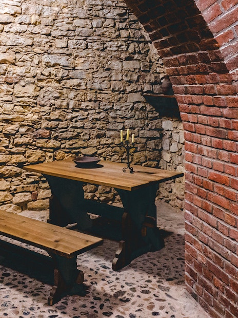 Prague medieval underground with stone walls and wooden table.