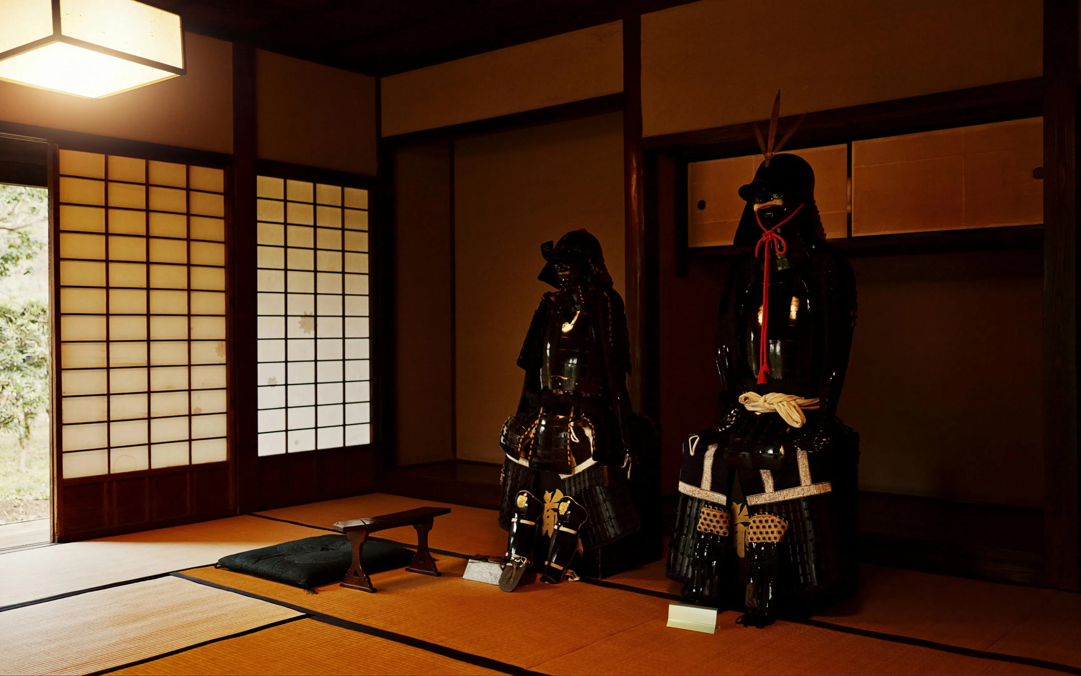 Samurai armor displayed in a traditional Japanese dojo room.