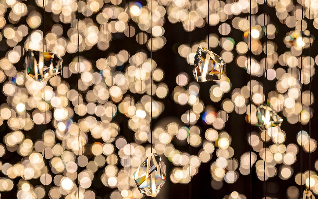 Hanging crystals at Swarovski Crystal Worlds with sparkling light reflections.