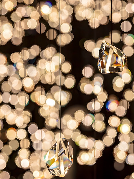 Hanging crystals at Swarovski Crystal Worlds with sparkling light reflections.