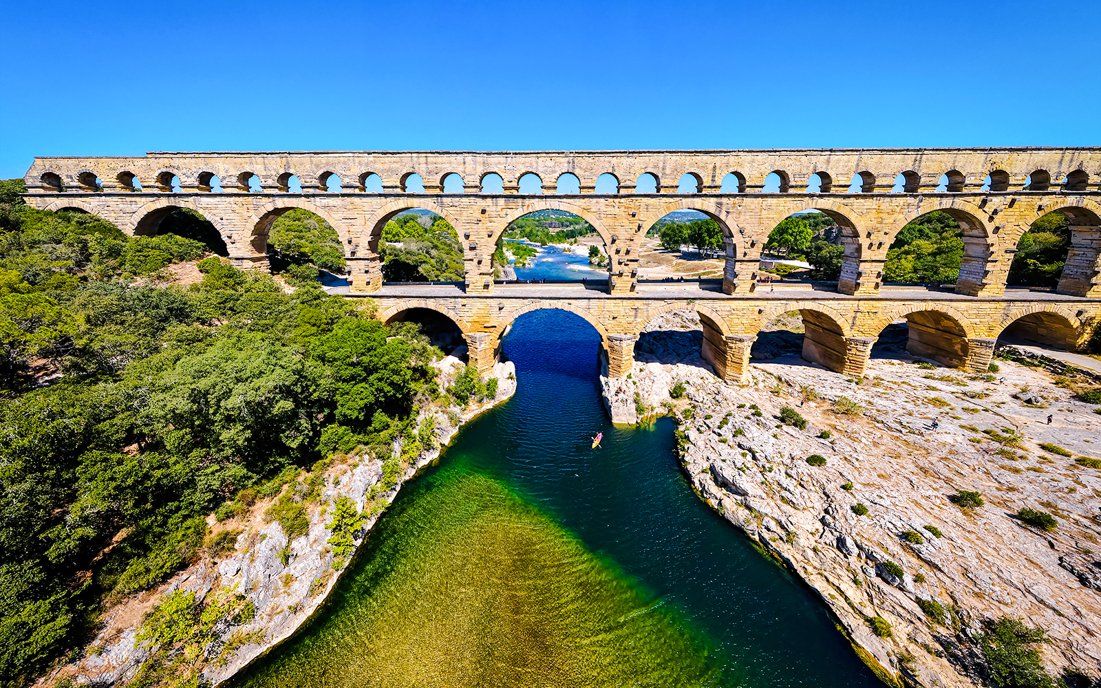 Aerial view of the Pont du Gard aqueduct spanning the Gardon River in southern France.