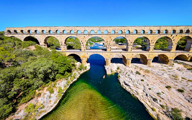 Aerial view of the Pont du Gard aqueduct spanning the Gardon River in southern France.
