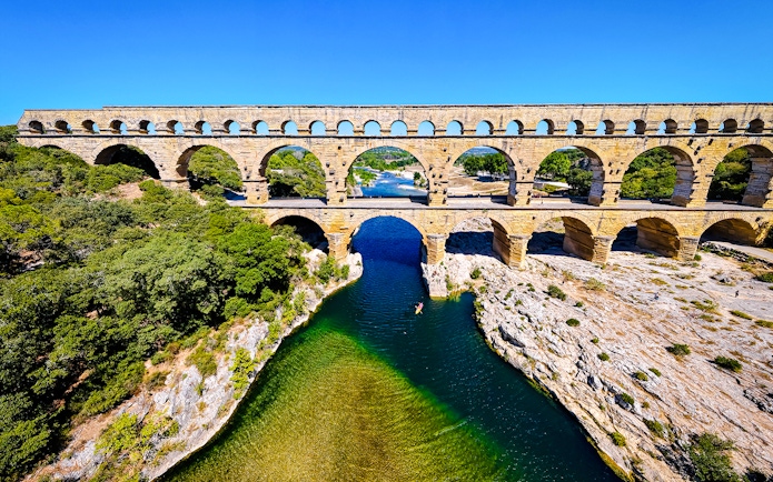 Aerial view of the Pont du Gard aqueduct spanning the Gardon River in southern France.