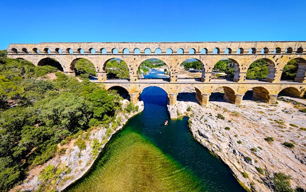 Aerial view of the Pont du Gard aqueduct spanning the Gardon River in southern France.