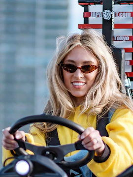 Person driving a go-kart on Shibuya streets during a tour in Tokyo.