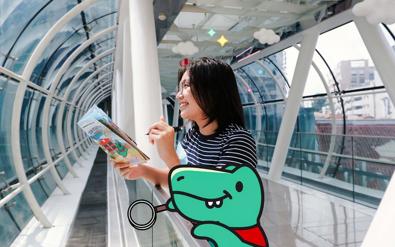 Young woman solving clues for “The Somerville Adventure” puzzle hunt in a glass tunnel.