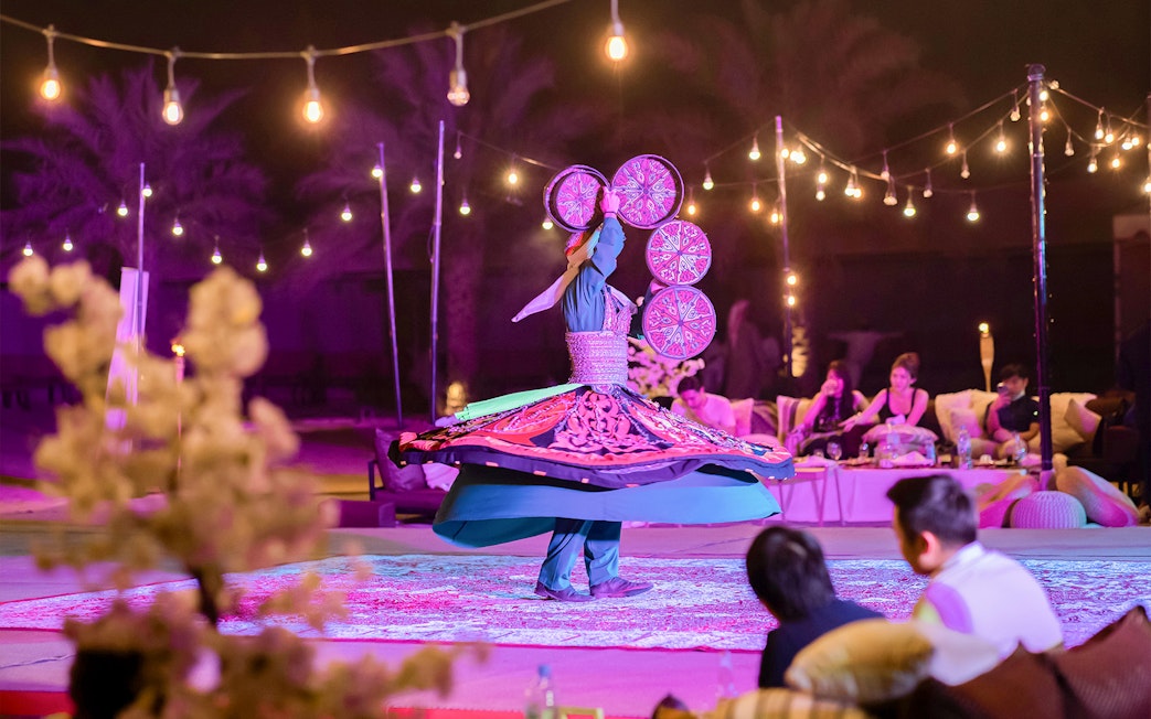 Traditional dancer spinning in a trance at Dubai Safari night experience.