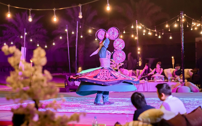 Traditional dancer spinning in a trance at Dubai Safari night experience.