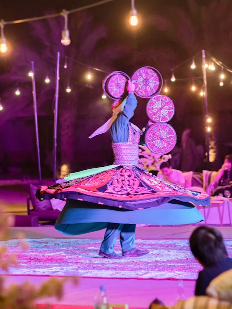 Traditional dancer spinning in a trance at Dubai Safari night experience.