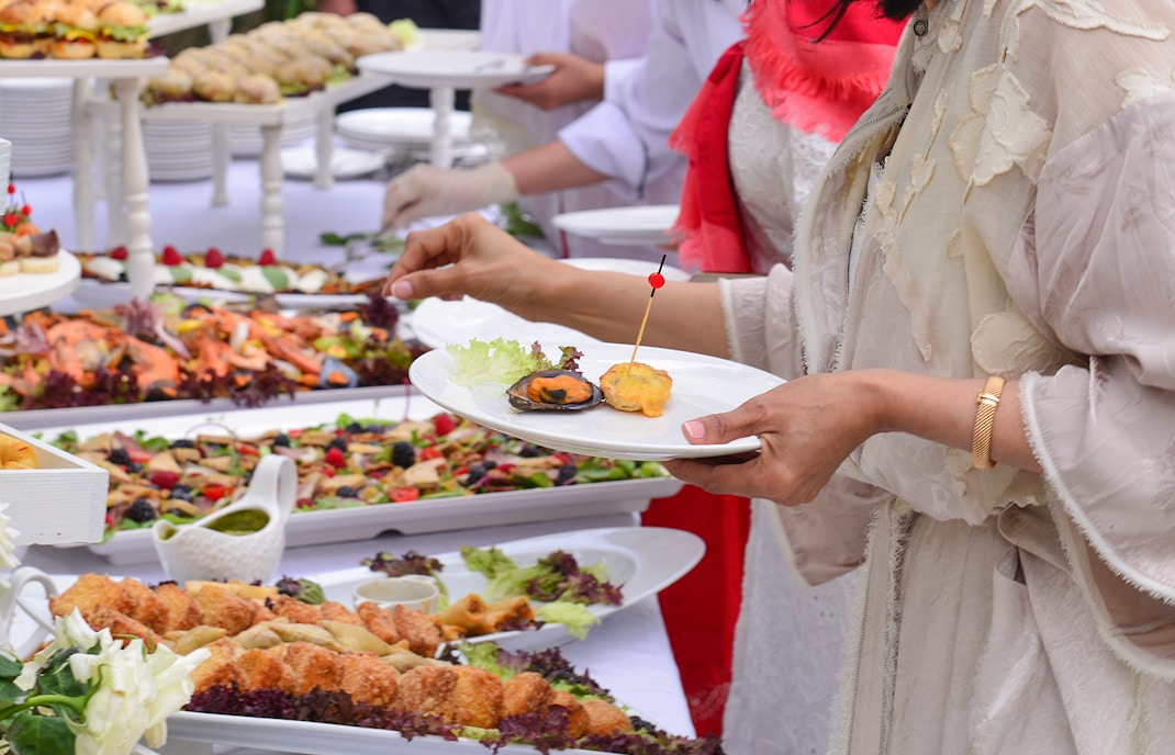 Mediterranean buffet with seafood, salads, and appetizers on display.