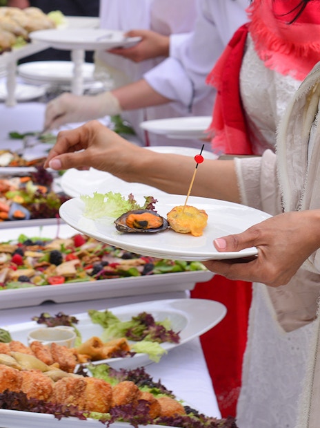 Mediterranean buffet with seafood, salads, and appetizers on display.