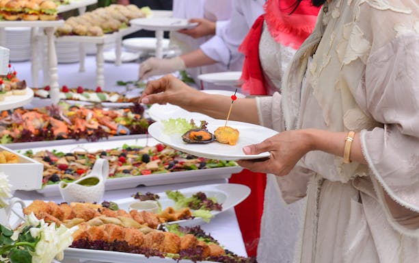 Mediterranean buffet with seafood, salads, and appetizers on display.