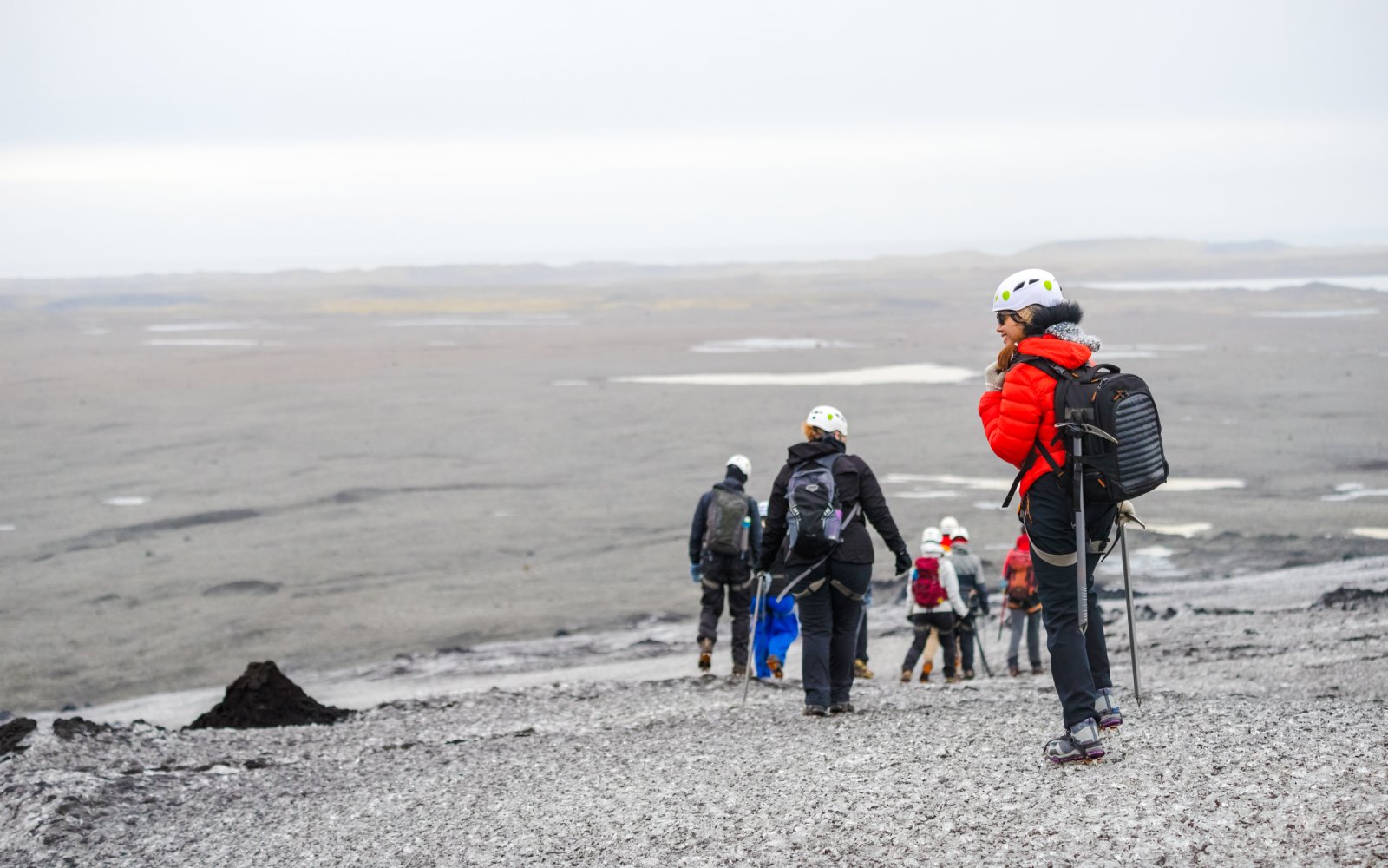 Hikers exploring Solheimajokull Glacier on South Coast tour.