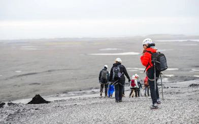 Hikers exploring Solheimajokull Glacier on South Coast tour.