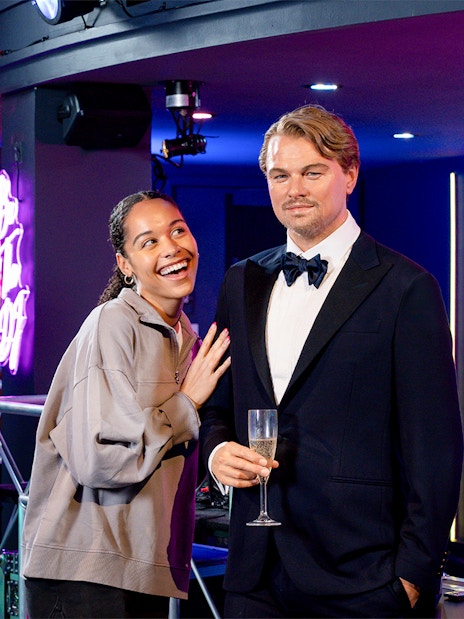 Girl posing with Leonardo DiCaprio wax figure at Madame Tussauds, New York.