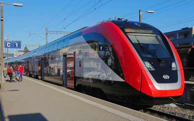 Train at Zurich central station platform for airport transfer.