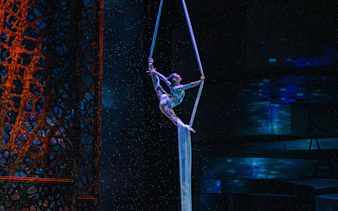 Aerialist performing aerobatics at La Perle show in Dubai.