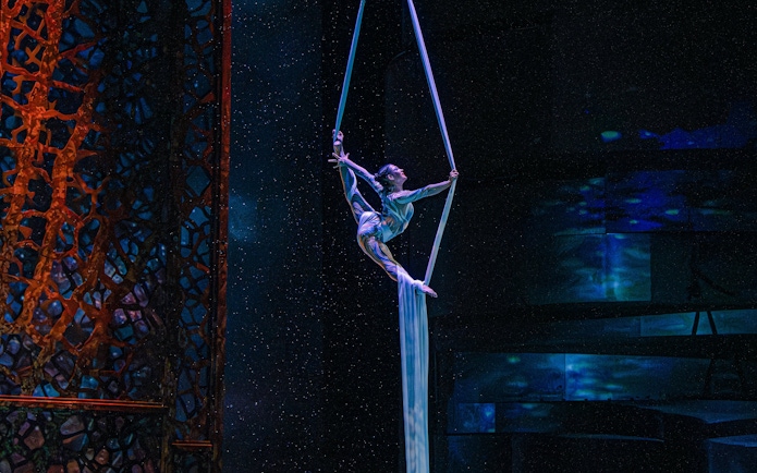 Aerialist performing aerobatics at La Perle show in Dubai.