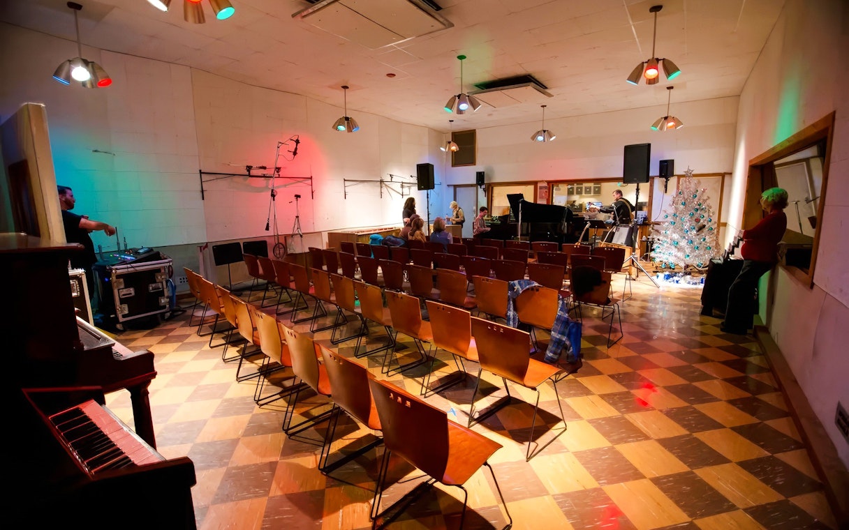 Historic RCA Studio B interior with seating, piano, and recording equipment.