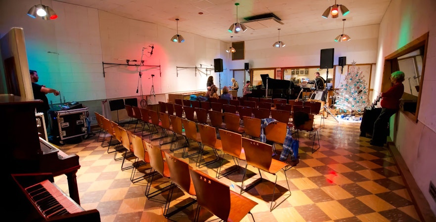 Historic RCA Studio B interior with seating, piano, and recording equipment.