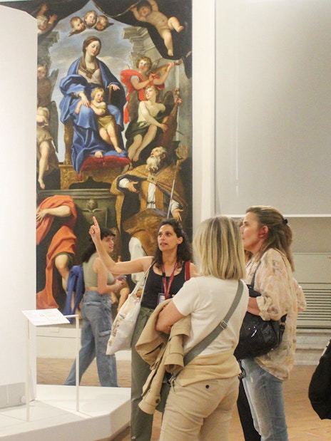 Visitors observing art during a guided tour at Palazzo Barberini, Rome.