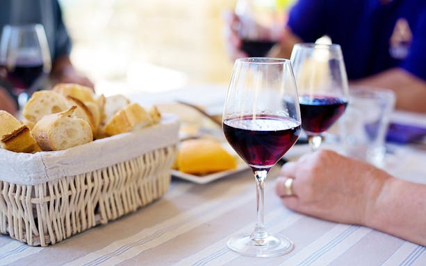 Wine glasses and bread basket on a table during a Krakow food and heritage tour.