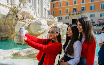 Friends taking a selfie at Trevi Fountain, Rome.