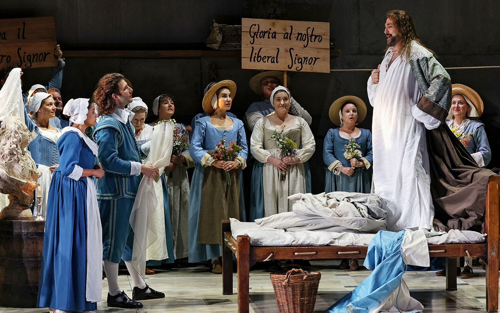 Opera scene from The Marriage of Figaro with performers in period costumes on stage.