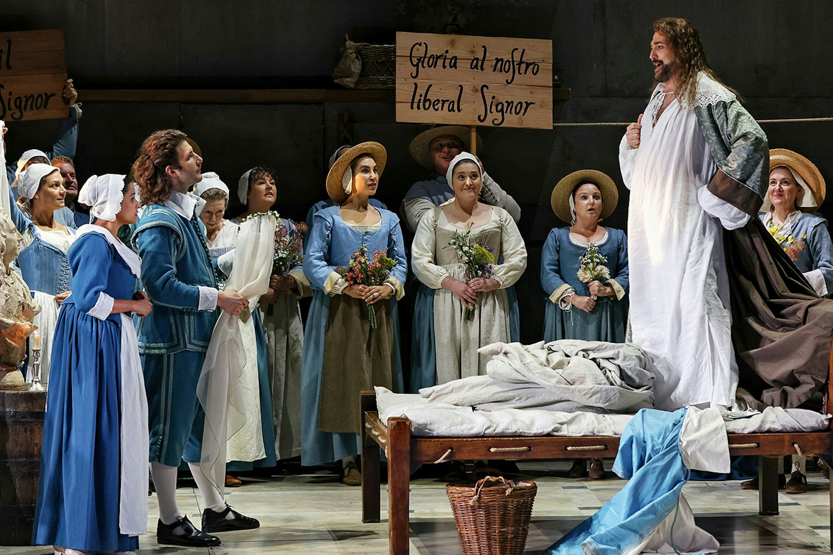 Opera scene from The Marriage of Figaro with performers in period costumes on stage.