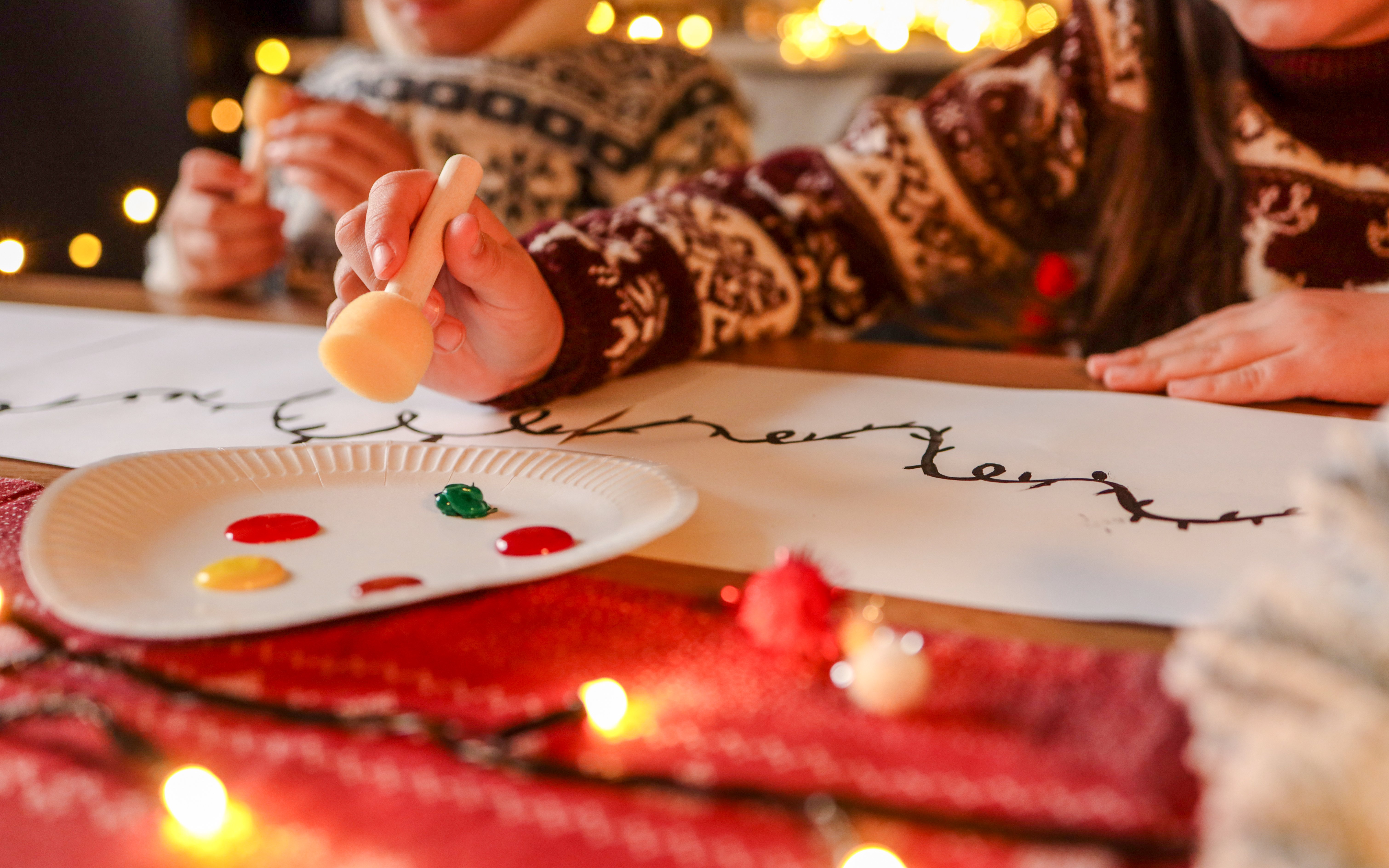 Children painting festive designs during Boston New Year celebration.