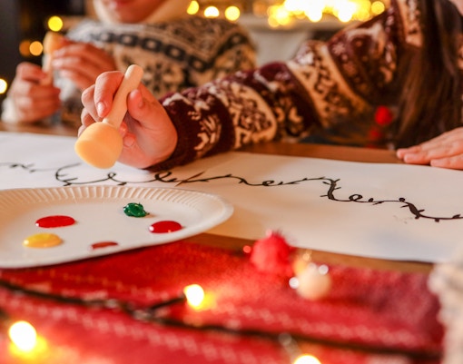 Children painting festive designs during Boston New Year celebration.